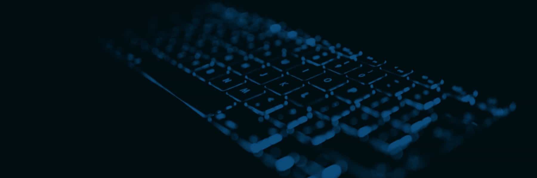 A dark, close up image of a computer or laptop keyboard, with a fluorescent blue light behind the keys, allowing them to stand out in the darkened image.